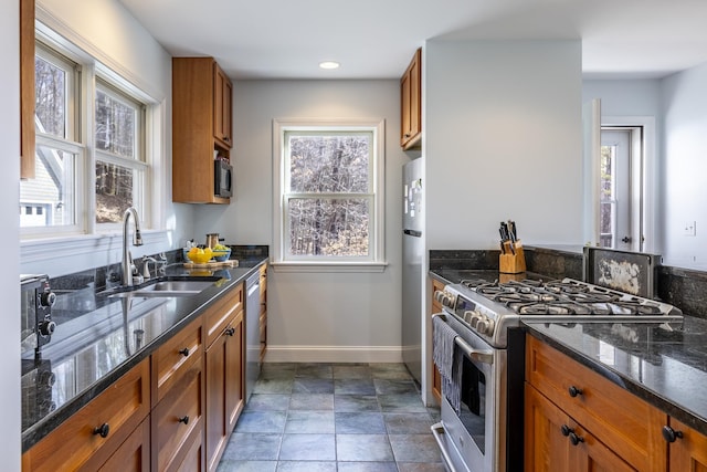 kitchen with a sink, brown cabinets, and appliances with stainless steel finishes