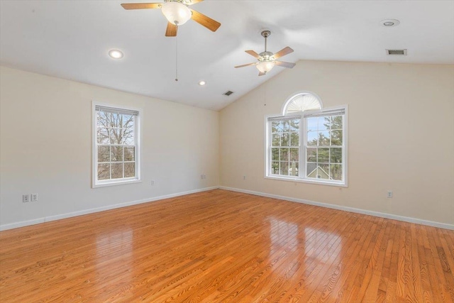 unfurnished room with plenty of natural light, a ceiling fan, visible vents, and light wood-type flooring