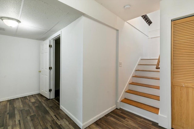 stairway with baseboards, wood finished floors, and visible vents