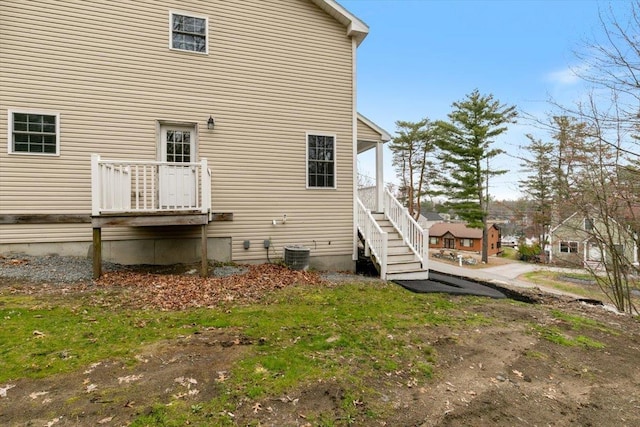 back of house featuring stairway and cooling unit