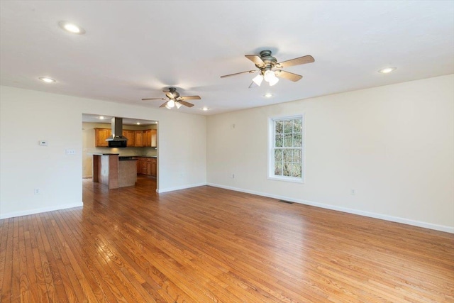 unfurnished living room featuring visible vents, baseboards, recessed lighting, ceiling fan, and hardwood / wood-style flooring