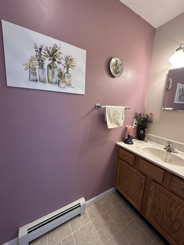 bathroom with baseboard heating, baseboards, and vanity