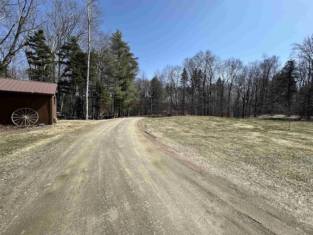 view of street featuring a wooded view