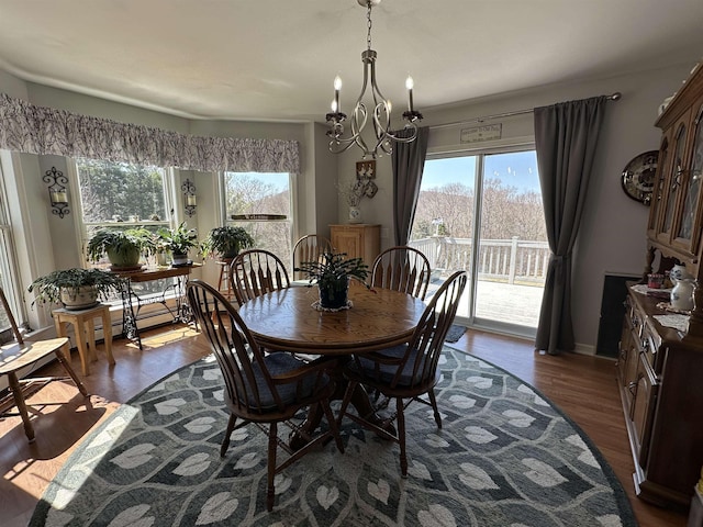 dining area featuring dark wood-style flooring and a notable chandelier