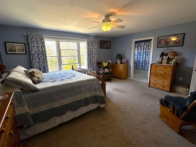 bedroom featuring a ceiling fan and light colored carpet