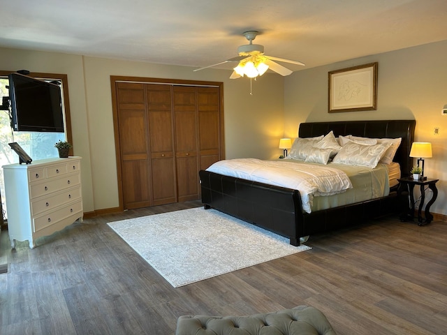 bedroom featuring wood finished floors, a closet, baseboards, and ceiling fan