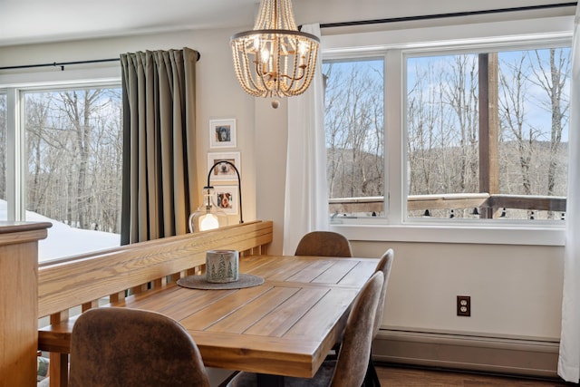 dining room featuring baseboard heating and a notable chandelier