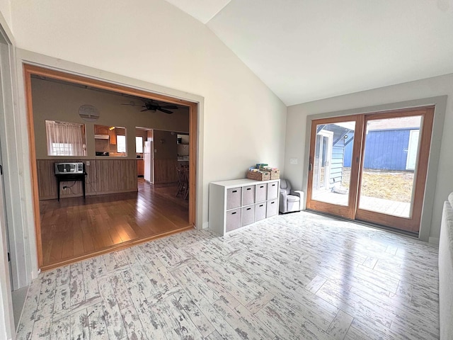 unfurnished room featuring vaulted ceiling, ceiling fan, and wood-type flooring