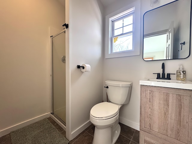 full bathroom with a shower stall, baseboards, toilet, and vanity