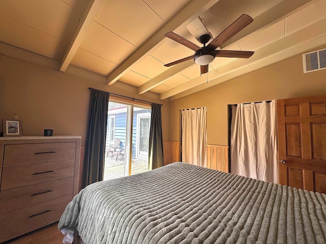bedroom featuring wood finished floors, vaulted ceiling with beams, visible vents, and a ceiling fan