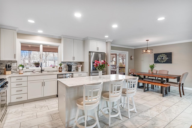 kitchen with marble finish floor, a sink, recessed lighting, and appliances with stainless steel finishes
