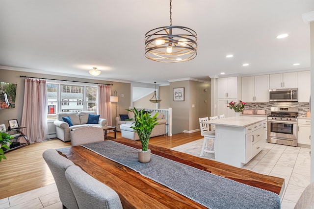 dining room featuring baseboards, recessed lighting, a notable chandelier, baseboard heating, and crown molding