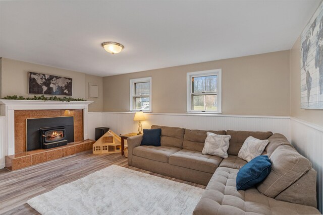 living room with a wainscoted wall and wood finished floors