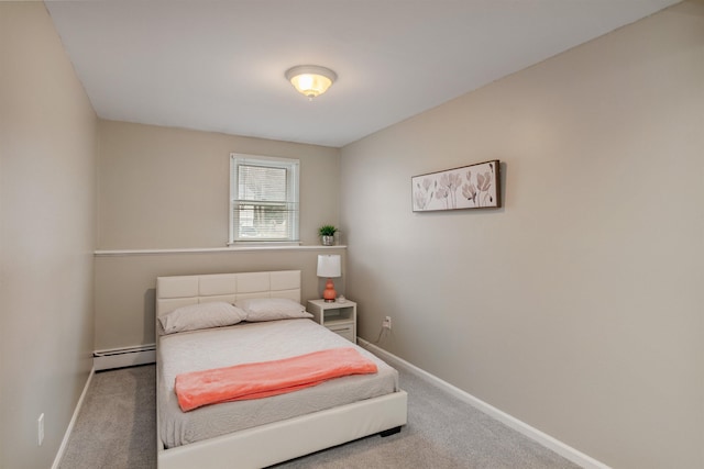 carpeted bedroom featuring a baseboard heating unit and baseboards
