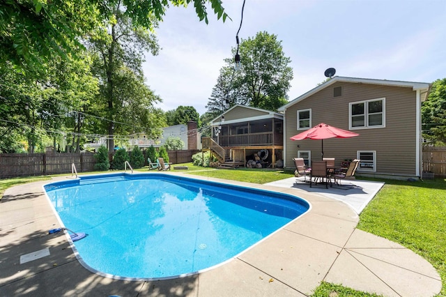 view of swimming pool featuring a lawn, a fenced backyard, a fenced in pool, and a sunroom