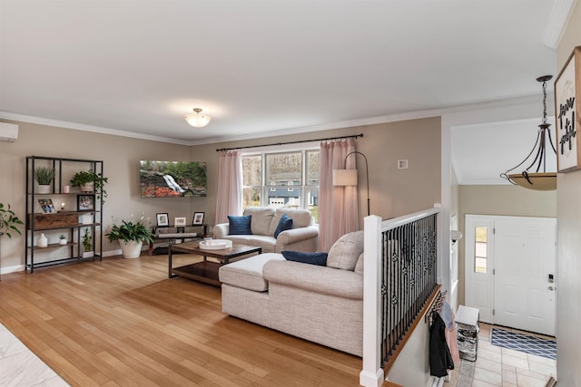 living area with a wall mounted air conditioner, baseboards, and ornamental molding