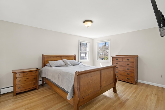 bedroom featuring baseboards and light wood finished floors