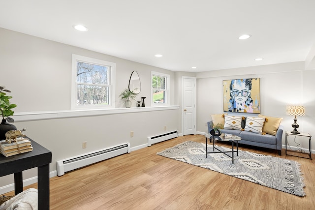 living area with recessed lighting, wood finished floors, baseboards, and baseboard heating