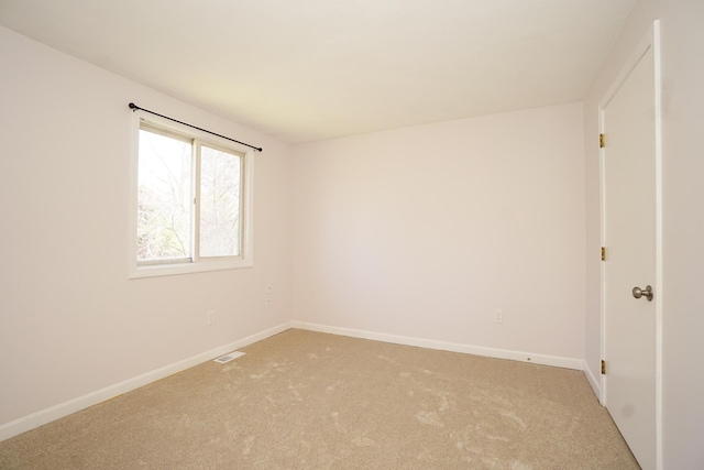 carpeted empty room with baseboards and visible vents