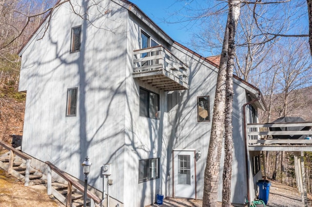 view of side of home with a balcony