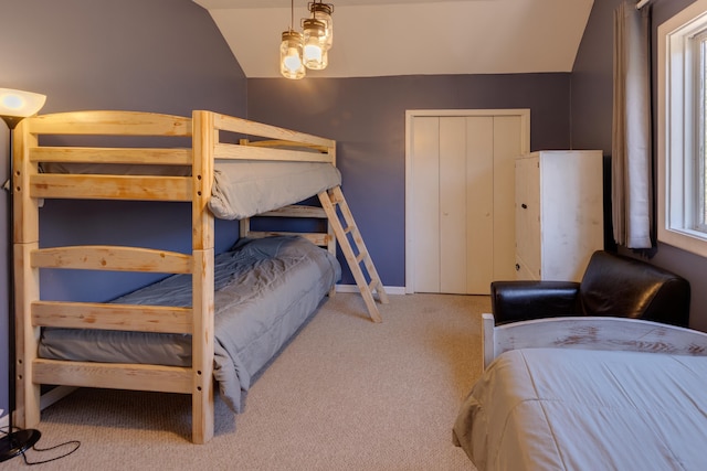 carpeted bedroom featuring lofted ceiling