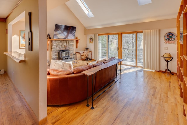 living room with high vaulted ceiling, baseboards, wood finished floors, and a skylight