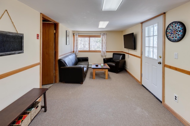 carpeted living room with a baseboard radiator