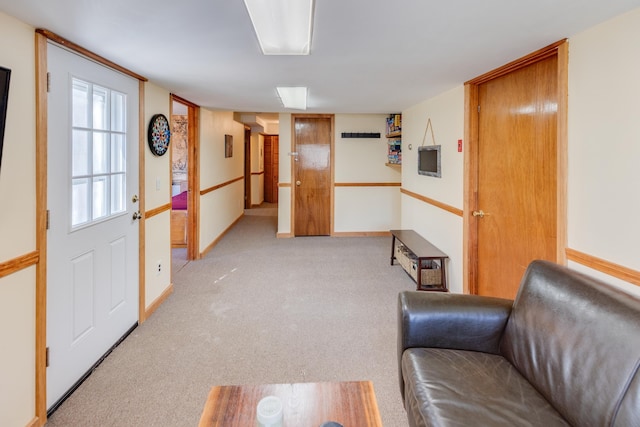 corridor with light colored carpet and baseboards