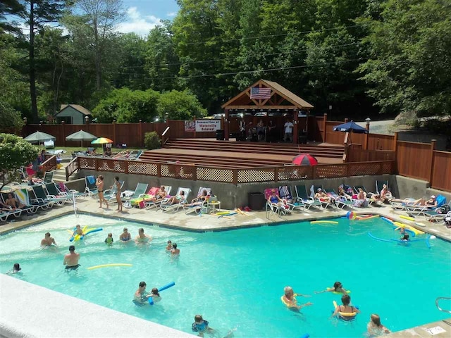 community pool featuring fence and a gazebo