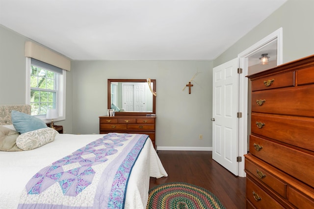 bedroom with baseboards and dark wood-style flooring