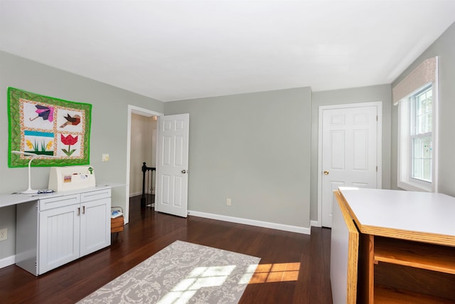 office featuring baseboards and dark wood-style flooring