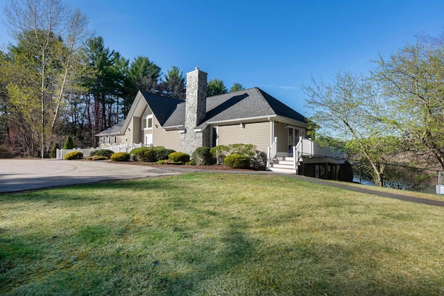 view of property exterior with a lawn and a chimney
