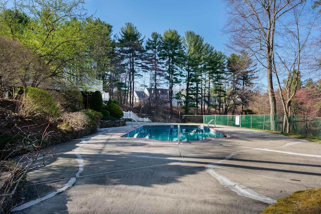 view of pool featuring fence, a fenced in pool, and a patio