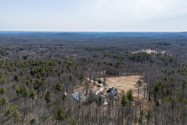 birds eye view of property featuring a forest view