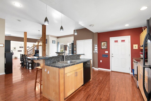 417 Locust St, Rollinsford, NH 03869 - kitchen with a sink, dishwasher, a kitchen breakfast bar, dark wood finished floors, and dark countertops