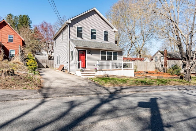 417 Locust St, Rollinsford, NH 03869 - view of front of house featuring fence, driveway, and a porch