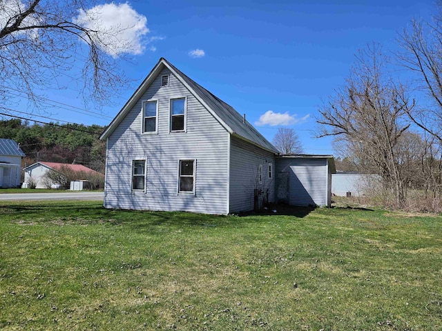 view of side of property with a yard