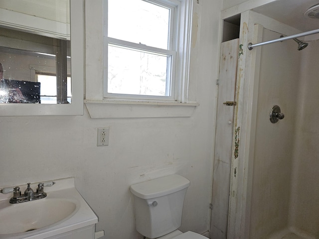 full bath featuring toilet, vanity, and a stall shower