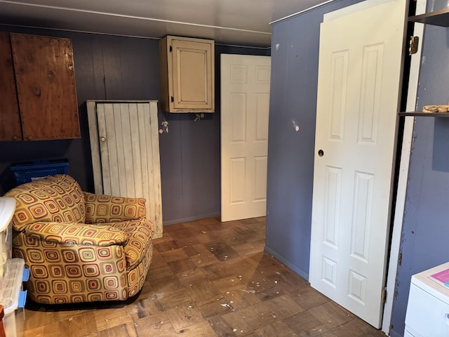 sitting room with dark floors and baseboards