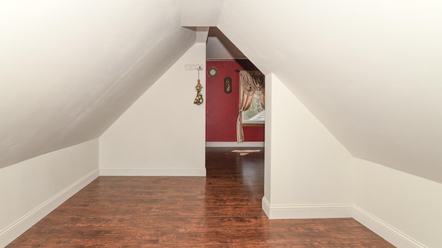 additional living space featuring lofted ceiling, wood finished floors, and baseboards