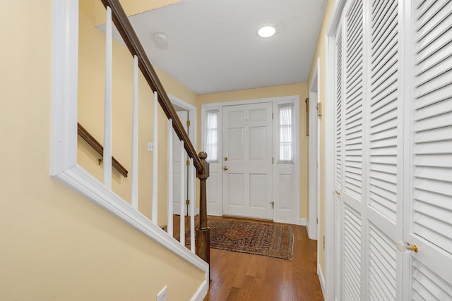 entryway featuring wood finished floors, recessed lighting, and stairs