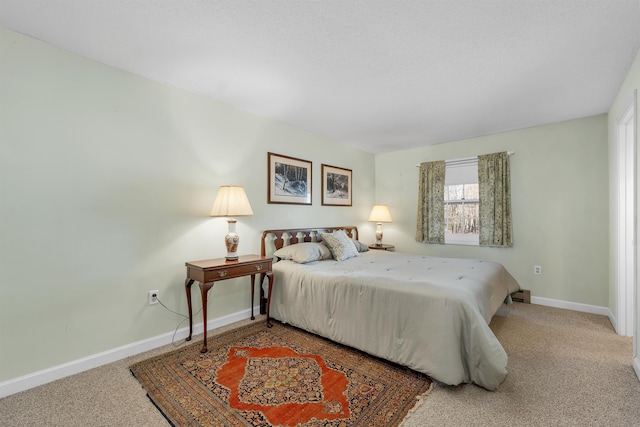 bedroom with carpet and baseboards