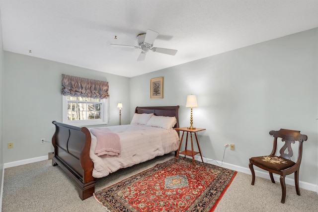 carpeted bedroom with ceiling fan and baseboards