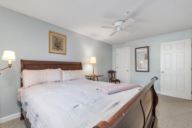 bedroom with ceiling fan, carpet flooring, and baseboards