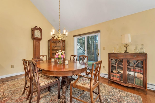 dining area with baseboard heating, wood finished floors, a chandelier, and baseboards