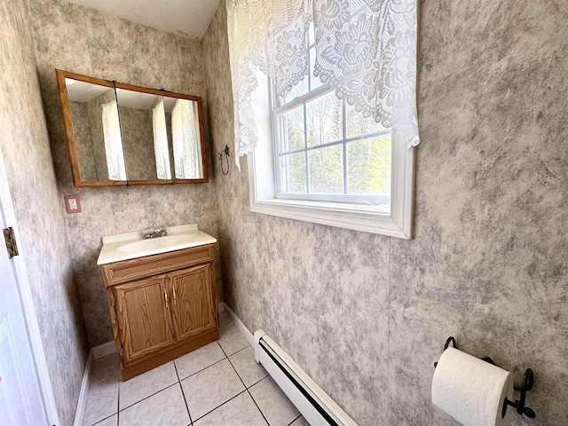 207 Blakely Farm Rd, Colebrook, NH 03576 - bathroom featuring a baseboard radiator, a baseboard heating unit, baseboards, vanity, and tile patterned flooring