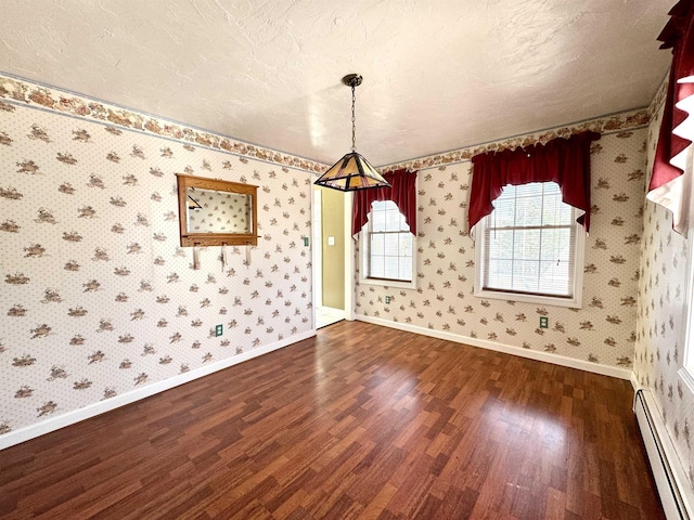 207 Blakely Farm Rd, Colebrook, NH 03576 - unfurnished dining area with wood finished floors, wallpapered walls, baseboard heating, and baseboards