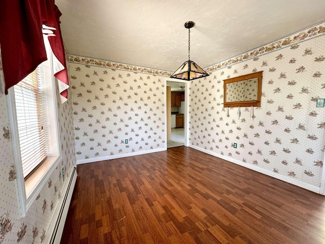 207 Blakely Farm Rd, Colebrook, NH 03576 - unfurnished dining area with baseboards, a baseboard heating unit, wallpapered walls, and dark wood finished floors