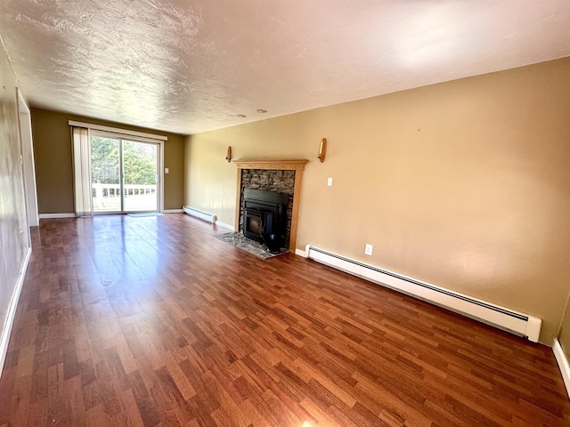 207 Blakely Farm Rd, Colebrook, NH 03576 - unfurnished living room with baseboards, wood finished floors, and a baseboard radiator