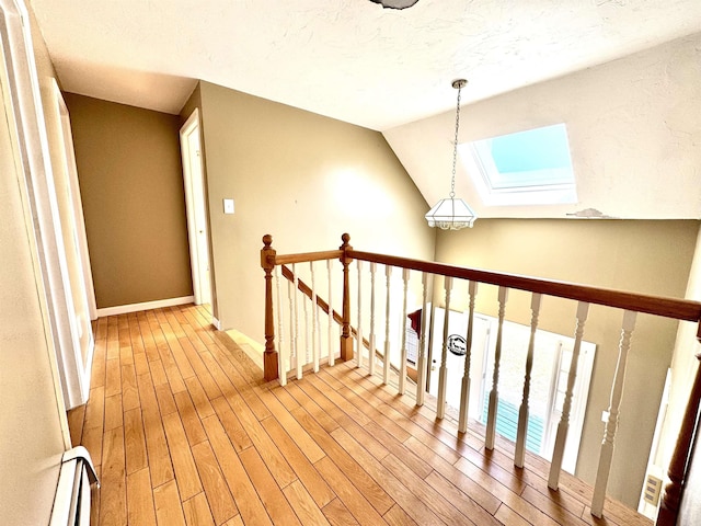 207 Blakely Farm Rd, Colebrook, NH 03576 - hall with baseboards, wood finished floors, an upstairs landing, and a baseboard radiator